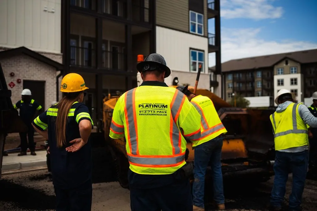 Platinum Paving workers outside of an apartment complex.