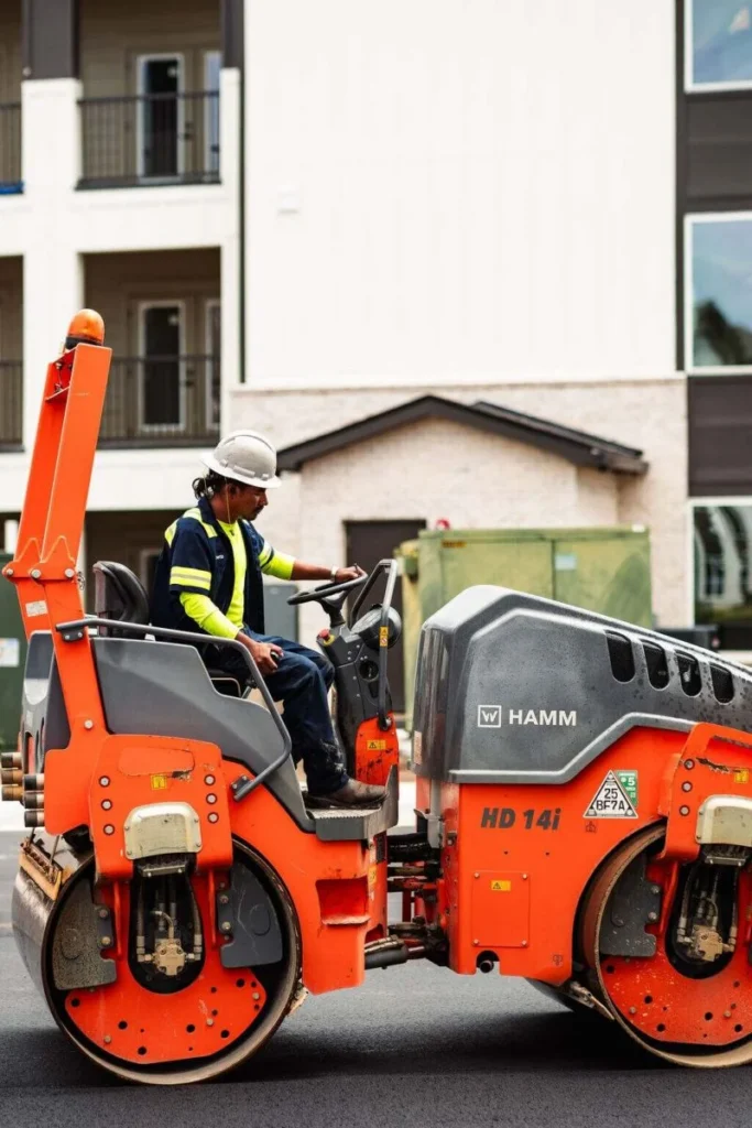 Platinum Paving worker operates a roller.