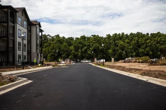 Durable Asphalt Maintenance Services in Georgia - Platinum Paving & Concrete A freshly paved road at an apartment complex.